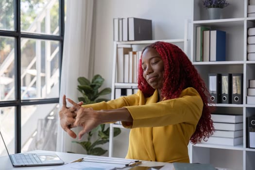 African American businesswoman has fatigue and headaches from working in the office..