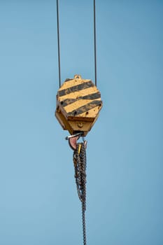 Yellow and black Crane Hook holding chains