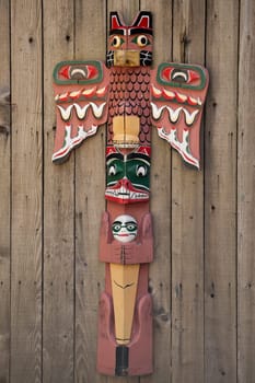 Isolated totem wood pole in the wood background