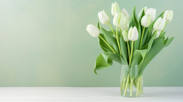 A clear vase with fresh white tulips against a soft green backdrop, symbolizing spring and natural elegance. High quality photo