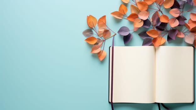 A book open on a blue background with paper flowers
