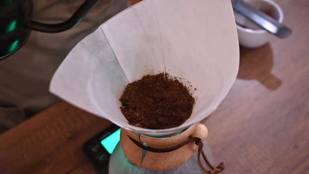 Barista pours water into the filter with coffee, brewing coffee. Alternative coffee-making methods