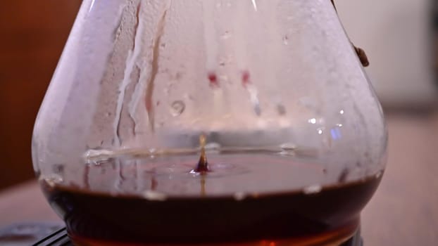 Barista pours water into the filter with coffee, brewing coffee. Alternative coffee-making methods