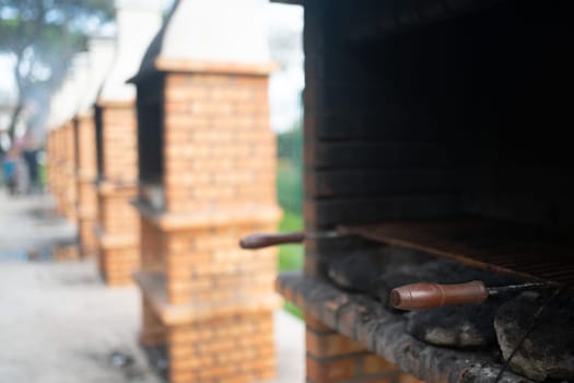Outdoor BBQ for cooking in public park. Red brick barbecues consist of solid foundations made from red bricks. Public place to have barbeque party in fresh air.