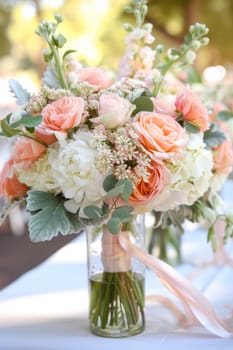 A vase of a bouquet with white and pink flowers on top