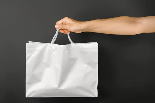 woman Hand holding white Shopping bag for mockup . AI generated image.