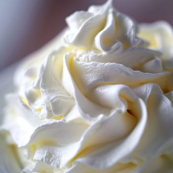 A close up of a bowl filled with whipped cream on top