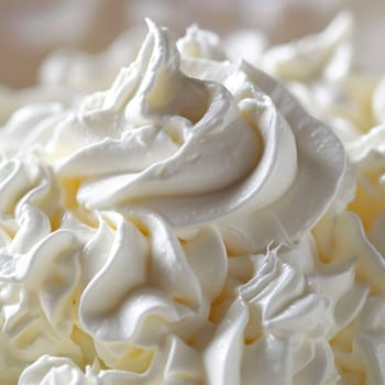 A close up of a bowl full of whipped cream with some white stuff on top