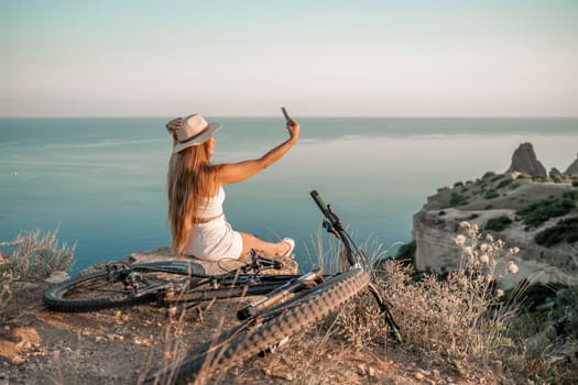 Selfie woman in cap and tank top making selfie shot mobile phone post photo social network outdoors on sea background beach people vacation lifestyle travel concept