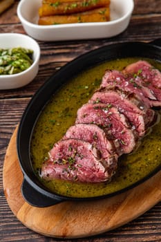 Sliced grilled tenderloin flavored with sauces after being seared on the grill