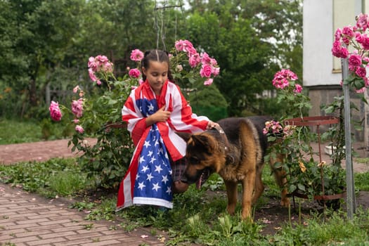 Pretty young pre-teen girl with an American cowboy hat in corn field and the holding American flag. High quality photo