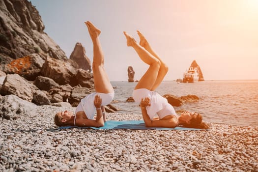 Woman sea yoga. Back view of free calm happy satisfied woman with long hair standing on top rock with yoga position against of sky by the sea. Healthy lifestyle outdoors in nature, fitness concept.