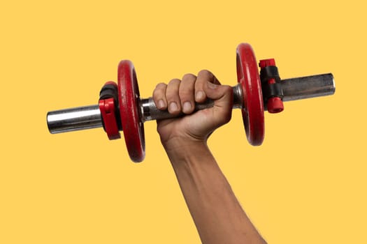 Black male hand holding an old dumbell isolated, no background. High quality photo