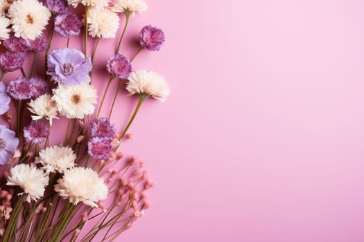 Pink horizontal background with a bouquet of lilac flowers.