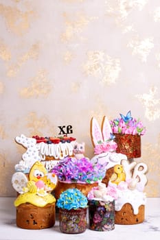 A variety of Easter cakes with intricate icing decorations, featuring bunnies, chicks, flowers, and butterflies. Perfect for a festive Easter celebration. Isolated on a beige background.