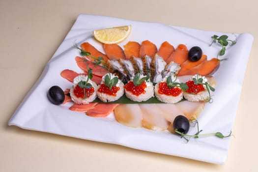 An artfully arranged platter of fresh seafood - salmon, trout, caviar, and shrimp - on a white plate with lemon slices and greens. A visually appealing still life composition.