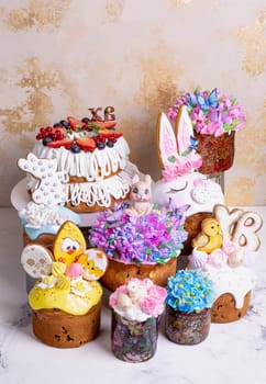 A variety of Easter cakes with intricate icing decorations, featuring bunnies, chicks, flowers, and butterflies. Perfect for a festive Easter celebration. Isolated on a beige background.