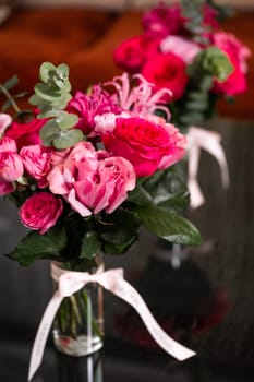 Vivid bouquet of pink and red roses in a glass vase against a black backdrop. Perfect for special occasions like Valentines Day or Mothers Day, this striking floral display is a heartfelt gift.