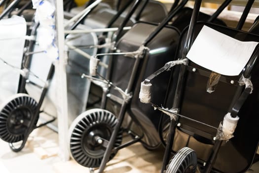 New black wheelbarrow in a store, close up wheel, construction and garden equipment