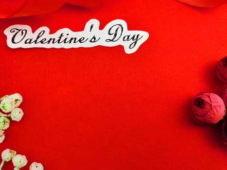 Valentine's Day concept celebration, congratulation. Red greeting Card with flower, Satin ribbon for Background, texture, place for text, copy space