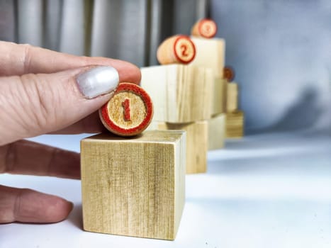 Small wooden cubes in columns, lined up in row and with numbers. Concept of stages of achieving goal. The need for the first step for the successful development and implementation of the project