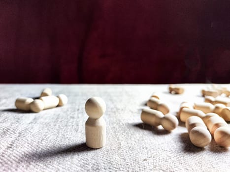 A lot of lying wooden toys and one standing one. There is an opportunity to win even when others give up. The strongest ones win. The loneliness of leader in business