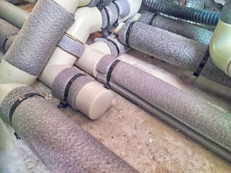 Complex Network of Insulated Pipes in an Industrial Setting. maze of thermally insulated pipes arranged in a complex network, part of an industrial heating or cooling system