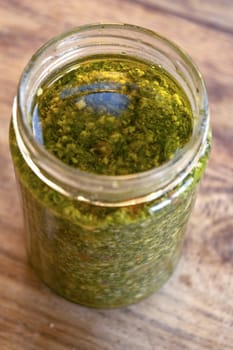 fresh homemade basil pesto placed in a glass jar