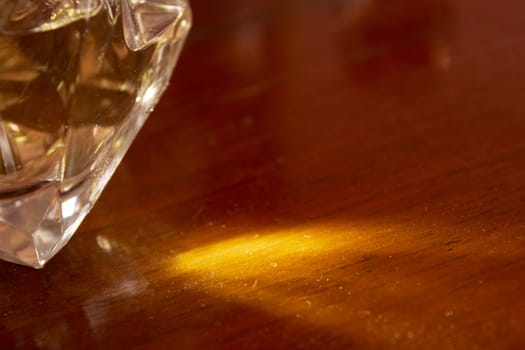 detail of a precious stone with light reflections on a wooden surface