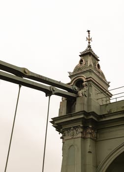London, UK -​ Dec 25, 2023 - Design Architecture of Hammersmith Bridge. One of the world's oldest suspension bridges and a major river crossing and primary route in west london, Space for text, Selective focus.