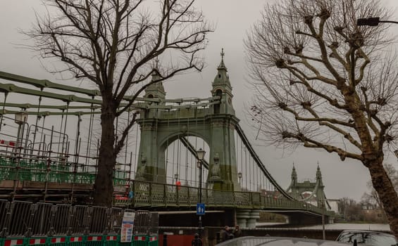 London, UK -​ Dec 25, 2023 - Hammersmith Bridge over the River Thames. One of the world's oldest suspension bridges and a major river crossing and primary route in west london, Space for text, Selective focus.