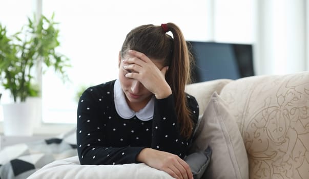 Close-up of frustrated young woman because of problem in personal life. Brunette depressed female close face with hand. Sadness and thoughtful mood concept