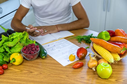 A nutritionist writes a nutrition plan. Selective focus. Food.