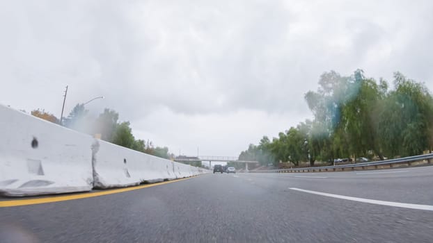 Amidst a rainy winter day, driving on HWY 134 near Los Angeles, California, captures the atmosphere through raindrop-covered lenses, adding a unique and moody perspective to the journey.