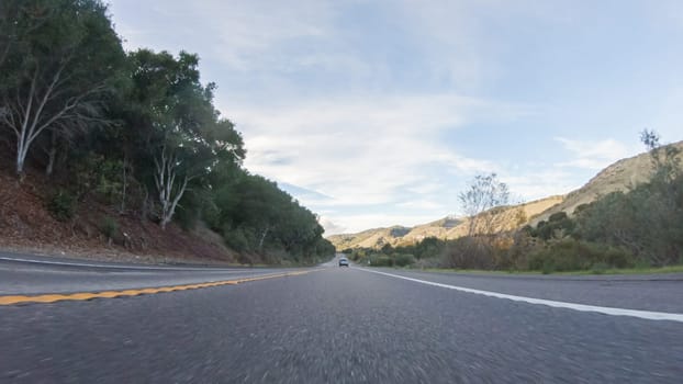 Basking in the beauty of a sunny winter day, driving on HWY 1 near Las Cruces, California offers stunning views of the picturesque coastal landscape against a backdrop of clear blue skies.