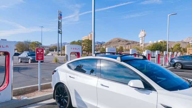 Primm, Nevada, USA-December 3, 2022-During the day, a Tesla vehicle is seen charging at a Tesla Supercharging station, utilizing the high-speed charging infrastructure for convenient and efficient electric vehicle refueling.