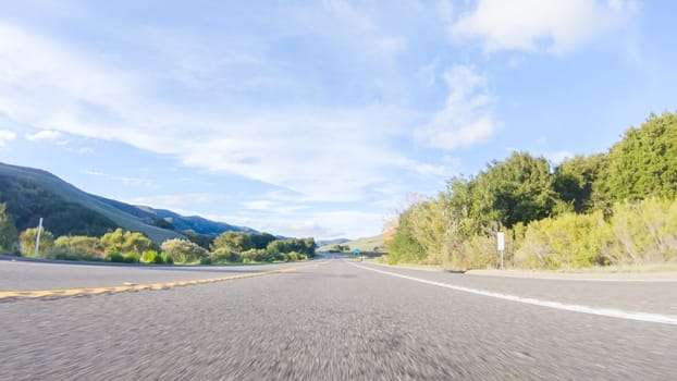 Basking in the beauty of a sunny winter day, driving on HWY 1 near Las Cruces, California offers stunning views of the picturesque coastal landscape against a backdrop of clear blue skies.