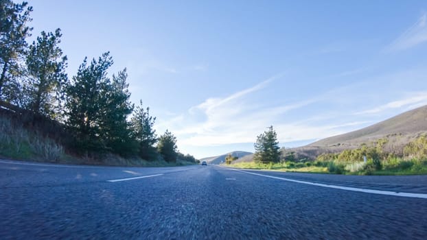 During the day, driving on HWY 101 near Arroyo Quemada Beach, California, offers scenic views of the surrounding coastal landscape.