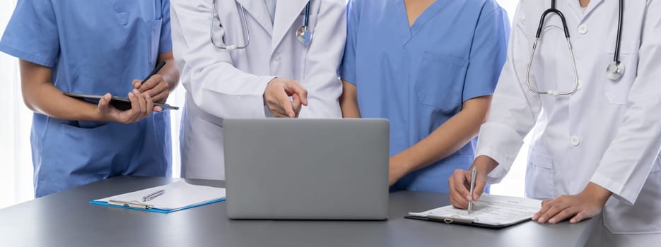 Doctor and nurse in medical meeting discussing strategic medical treatment plan together with report and laptop. Medical school workshop training concept in panoramic banner. Neoteric