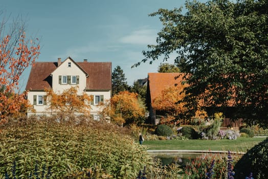 House with nice garden in fall. Flowers in the Park. Bietigheim-Bissingen. Germany, Europe. Autumn Park and house, nobody, bush and grenery