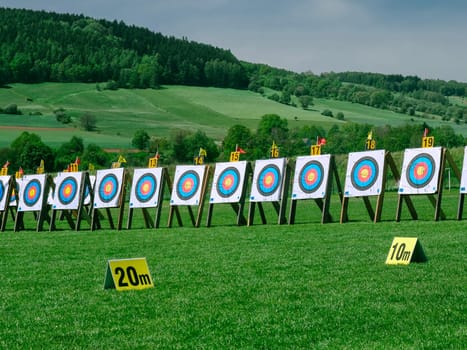 Row of training boards for archery in a field against a background of green grass. High quality photo