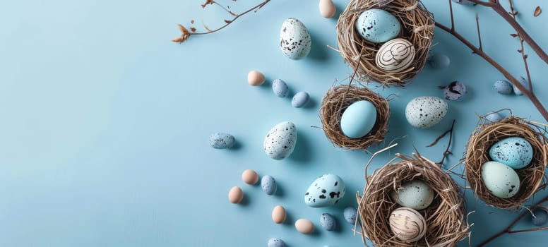 Easter Eggs Nestled in Straw on Pastel Blue Background.