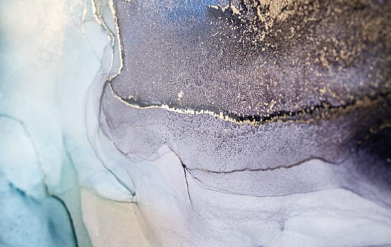 Blue and gold alcohol ink. Style incorporates the swirls of marble or the ripples of agate. Abstract painting, trendy background for wallpapers, posters, cards, invitations, websites.