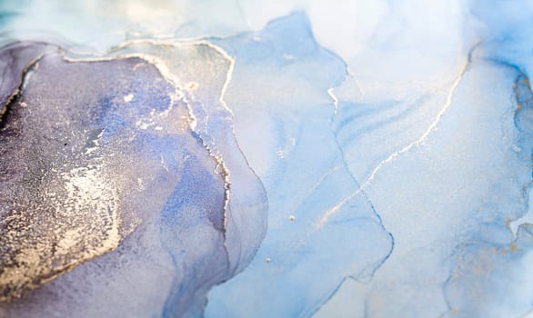 Blue and gold alcohol ink. Style incorporates the swirls of marble or the ripples of agate. Abstract painting, trendy background for wallpapers, posters, cards, invitations, websites.