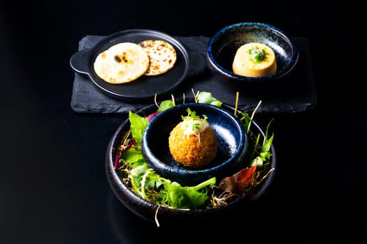 Closeup of some spanish croquettes in bed of lettuce served as tapas