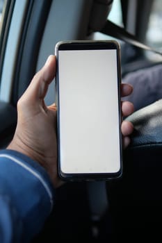 hand holding smart phone with empty screen in a car ,