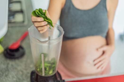 Embracing a nutritious choice, a pregnant woman joyfully prepares a vibrant vegetable smoothie, prioritizing wholesome ingredients for optimal well-being during her maternity journey.