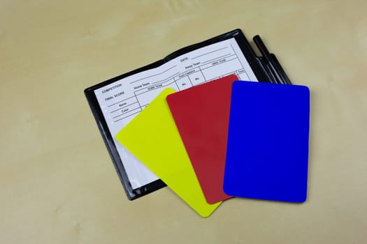 Football referee cards with new blue card lie in an open notebook to indicate player substitutions, changes in regulations