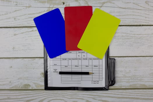 Referee soccer cards of different colors and notepad with pencil to mark player substitutions, referee set concept, for pocket on jersey