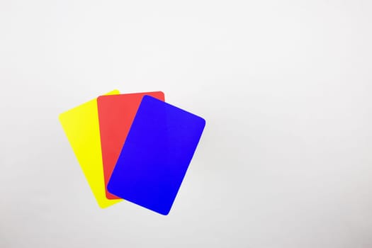 Three cards for football referee on a white table. Blue, red, yellow cards in football after changing the rules